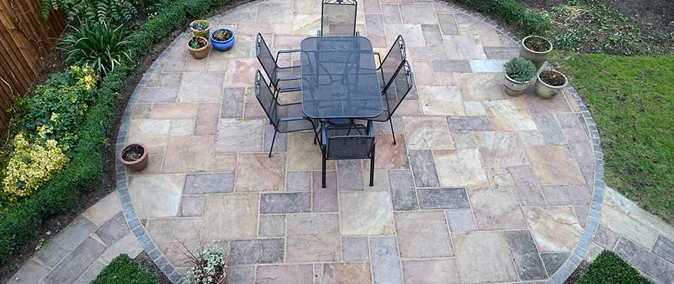 Natural stone patio with seating at a Orlando, FL home.