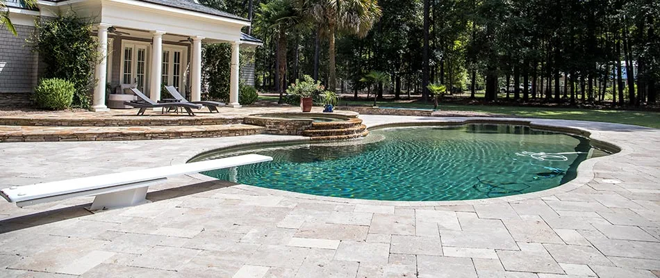 Stone paver pool patio deck and diving board near Clermont, FL.