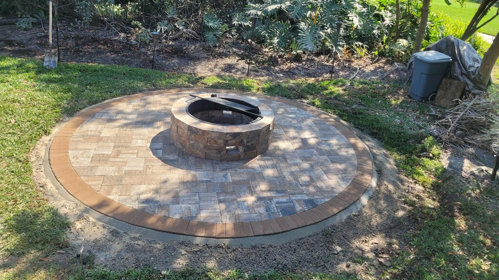 A stone fire pit and custom patio construction at a Clermont, FL property.